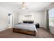 This bedroom has a ceiling fan, a bed, and a window at 625 Outlook Way, Atlanta, GA 30349