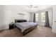 This bedroom has a ceiling fan, a bed, and a window at 625 Outlook Way, Atlanta, GA 30349