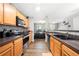 Well-lit kitchen with stainless steel appliances, dark countertops, and hardwood floors at 625 Outlook Way, Atlanta, GA 30349