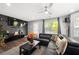 Cozy living room features a dark accent wall, large TV, and a comfortable sectional sofa at 625 Outlook Way, Atlanta, GA 30349
