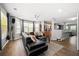 Open concept living room, with an accent wall, hardwood floors, and lots of natural light at 625 Outlook Way, Atlanta, GA 30349