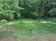 A view of the grassy backyard and surrounding trees at 861 Creek Nw Trl, Kennesaw, GA 30144