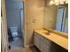 Bathroom view from doorway showing large mirror, vanity with counterspace and toilet and shower at 861 Creek Nw Trl, Kennesaw, GA 30144