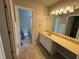 Bathroom view showing vanity with plenty of counterspace and storage as well as toilet and shower with open doorway at 861 Creek Nw Trl, Kennesaw, GA 30144