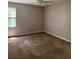 Spacious bedroom featuring carpeted flooring and a window providing natural light at 861 Creek Nw Trl, Kennesaw, GA 30144