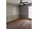 Comfortable bedroom featuring neutral walls, carpet, window with blinds, and a ceiling fan at 861 Creek Nw Trl, Kennesaw, GA 30144