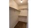 Walk-in closet with a light fixture and plenty of shelving for storage and organization at 861 Creek Nw Trl, Kennesaw, GA 30144