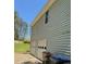 Home exterior showcasing a two-car garage, weathered siding, and a green lawn at 861 Creek Nw Trl, Kennesaw, GA 30144