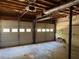 Unfinished garage interior showcasing the exposed beam ceiling and two white garage doors at 861 Creek Nw Trl, Kennesaw, GA 30144