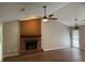 Spacious living room with brick fireplace, ceiling fan and modern chandelier at 861 Creek Nw Trl, Kennesaw, GA 30144