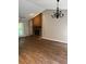 Bright living room featuring brick fireplace, hardwood floors, and chandelier at 861 Creek Nw Trl, Kennesaw, GA 30144