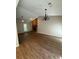 Living room featuring brick fireplace, hardwood floors, ceiling fan and chandelier at 861 Creek Nw Trl, Kennesaw, GA 30144