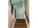 Carpeted staircase with white banisters and a black handrail leading to the upper level at 861 Creek Nw Trl, Kennesaw, GA 30144