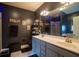 Modern bathroom with gray cabinets, double sinks, framed mirrors, and a walk-in shower at 8664 Spivey Village Trl, Jonesboro, GA 30236