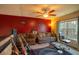 Eclectic bedroom featuring two couches, guitars, and a ceiling fan at 8664 Spivey Village Trl, Jonesboro, GA 30236