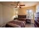 Cozy bedroom with a ceiling fan, natural light, and neutral decor at 8664 Spivey Village Trl, Jonesboro, GA 30236