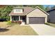 Charming brick home featuring a manicured lawn and a two-car garage at 8664 Spivey Village Trl, Jonesboro, GA 30236