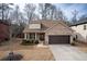 Charming brick home with manicured lawn and a two-car garage, creating a welcoming curb appeal at 8664 Spivey Village Trl, Jonesboro, GA 30236