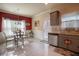 Eat-in kitchen featuring stainless steel appliances, gray cabinets, granite countertops, and tile backsplash at 8664 Spivey Village Trl, Jonesboro, GA 30236