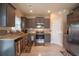 Stylish kitchen featuring stainless steel appliances, gray cabinets, granite countertops, and tile backsplash at 8664 Spivey Village Trl, Jonesboro, GA 30236