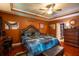 Beautiful primary bedroom with a tray ceiling, recessed lighting, and a door leading to the bathroom at 8664 Spivey Village Trl, Jonesboro, GA 30236