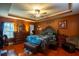 Spacious main bedroom with a tray ceiling, hardwood floors, and decorative furnishings at 8664 Spivey Village Trl, Jonesboro, GA 30236