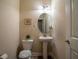 Traditional powder room featuring a pedestal sink, oval mirror, and wood look flooring at 8664 Spivey Village Trl, Jonesboro, GA 30236