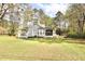 Backyard view of the home and property, surrounded by mature trees at 24 Lady Savannah Dr, Dallas, GA 30157
