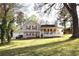 Charming home with a covered porch, red shutters, gray siding, and a detached two-car garage at 24 Lady Savannah Dr, Dallas, GA 30157