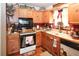 Quaint kitchen with wooden cabinets, black appliances, and charming country decor at 24 Lady Savannah Dr, Dallas, GA 30157