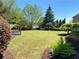 Well-maintained backyard with lush lawn, mature trees, and garden beds, perfect for outdoor enjoyment at 311 Carmichael Cir, Canton, GA 30115