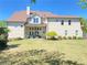 Expansive backyard featuring a well-manicured lawn and a covered patio with outdoor seating at 311 Carmichael Cir, Canton, GA 30115