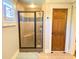 Tiled shower with glass door and bench in bathroom at 311 Carmichael Cir, Canton, GA 30115