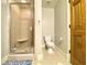 Bathroom featuring shower, toilet, patterned rug, and wood door at 311 Carmichael Cir, Canton, GA 30115
