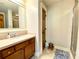 Bathroom featuring wood cabinets, a sink, mirror, and a glass shower at 311 Carmichael Cir, Canton, GA 30115