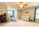 Welcoming Bedroom with crib, chair, ceiling fan, and turtle artwork at 311 Carmichael Cir, Canton, GA 30115