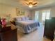 Large bedroom featuring a queen bed, ceiling fan, and sitting area with natural light at 311 Carmichael Cir, Canton, GA 30115