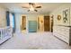Spacious Bedroom with crib, dresser, and ceiling fan at 311 Carmichael Cir, Canton, GA 30115