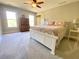 Bedroom features neutral colors, a ceiling fan and a wooden dresser at 311 Carmichael Cir, Canton, GA 30115