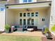 Inviting covered patio featuring a comfortable seating area and a ceiling fan for relaxed outdoor living at 311 Carmichael Cir, Canton, GA 30115