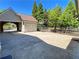 Spacious driveway with a basketball hoop, garage, and lush landscaping at 311 Carmichael Cir, Canton, GA 30115