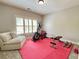 Bright exercise room with an elliptical, bench, weights, and a comfortable lounge at 311 Carmichael Cir, Canton, GA 30115