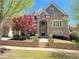 Elegant brick home with front porch, manicured landscaping, and charming curb appeal at 311 Carmichael Cir, Canton, GA 30115