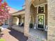 Welcoming front porch with brick archways, ceiling fan, and decorative wreath and bunny accents at 311 Carmichael Cir, Canton, GA 30115
