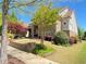 Beautiful brick home featuring lush landscaping, mature trees, and a manicured lawn at 311 Carmichael Cir, Canton, GA 30115