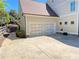 Exterior view of the garage with a driveway and manicured landscaping at 311 Carmichael Cir, Canton, GA 30115