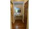 Hallway features hardwood floors, neutral paint, and elegant wall decor at 311 Carmichael Cir, Canton, GA 30115
