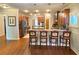 Open concept kitchen with hardwood floors, stainless steel appliances, and bar seating at 311 Carmichael Cir, Canton, GA 30115