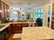 Open kitchen with granite counters, hardwood floors, stainless appliances, and bright lighting at 311 Carmichael Cir, Canton, GA 30115