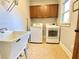 Well-equipped laundry room with appliances, utility sink and storage cabinets at 311 Carmichael Cir, Canton, GA 30115